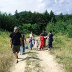 A family walking along a grassy mountain path