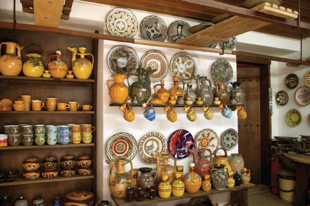 Shelves of glazed traditional pottery in a craftsman's workshop